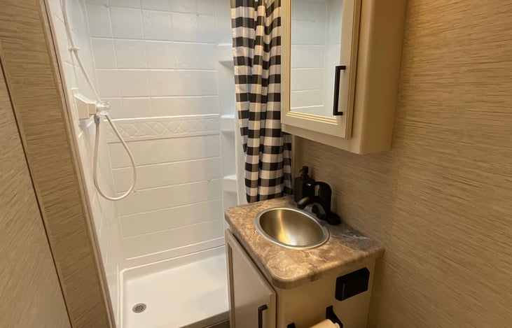 Hot and cold water, stainless steel wash sink and foot pedal flushing toilet and modern fixtures.