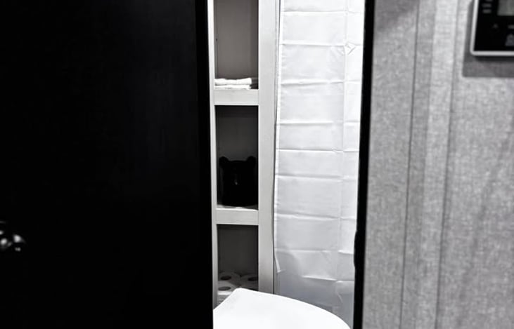 A bright, space‑efficient bathroom with fresh linens and organized shelving, giving renters a clean and comfortable place to get ready.