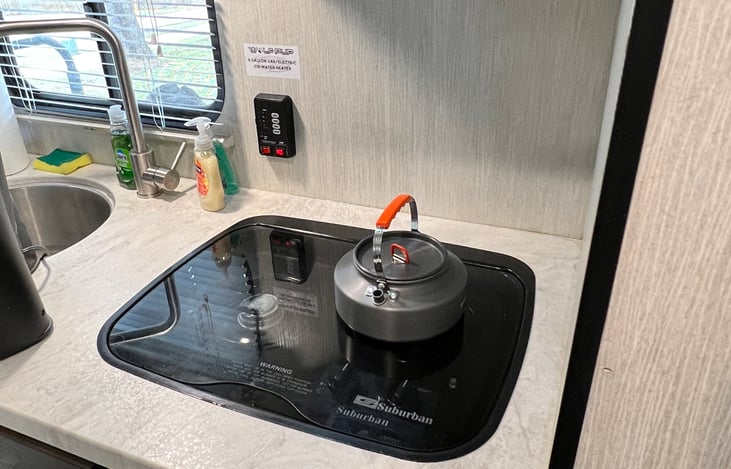 Tea kettle, propane stove.