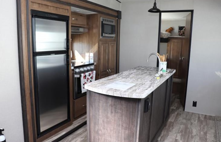 Kitchen area. Refrigerator/freezer, sink, stove/oven, microwave & pantry.