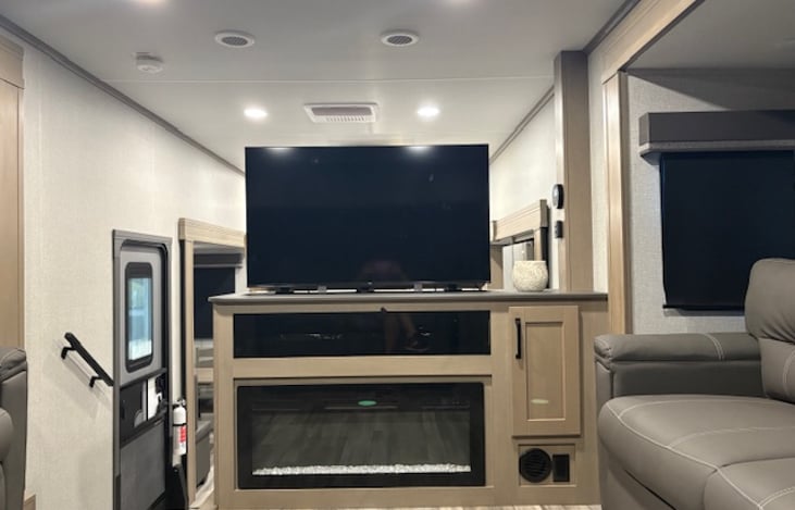 The entertainment center features a 50" TV on a lift, LED fireplace and Bluetooth Stereo.