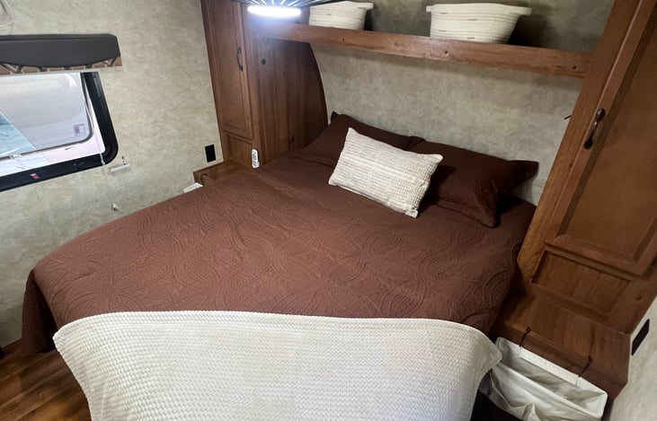 Stretch out and relax in the spacious queen bed, complete with a residential-style mattress, dual wardrobes, overhead storage, bedside nightstands, and a ceiling fan.
