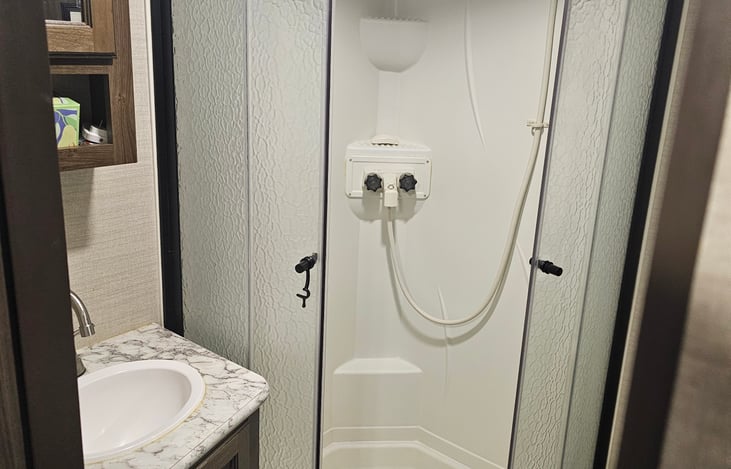 Master bathroom with large corner shower, sink and toilet.