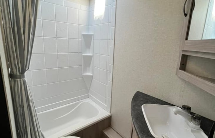 The shower is tall enough to accommodate heights of 6'4" without issue!