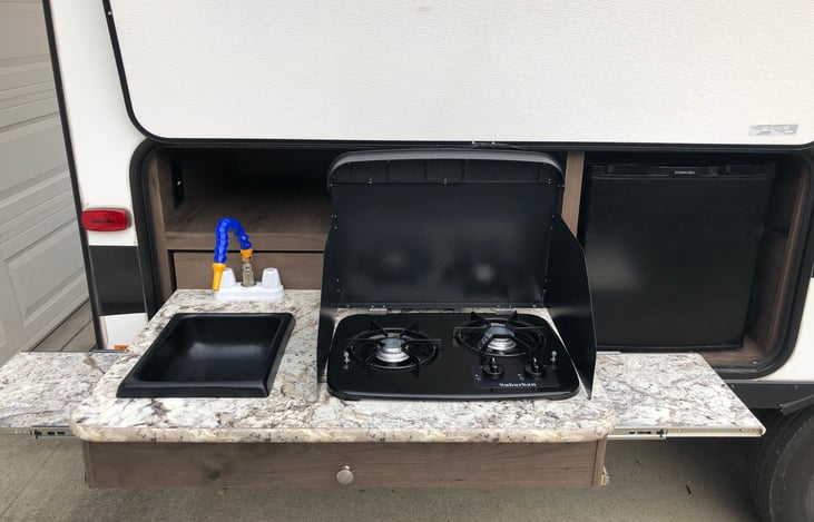 Outdoor Kitchen. Water, propane stove top, and mini fridge.