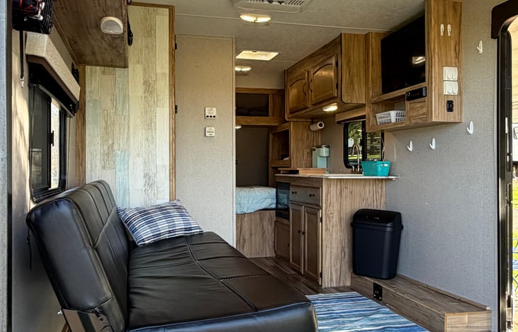 Relax on the cozy leather couch and unwind with TV after a fun day outdoors. The RV includes a Roku so you can sign into your favorite streaming channels by connecting to your local Wi-Fi hotspot.