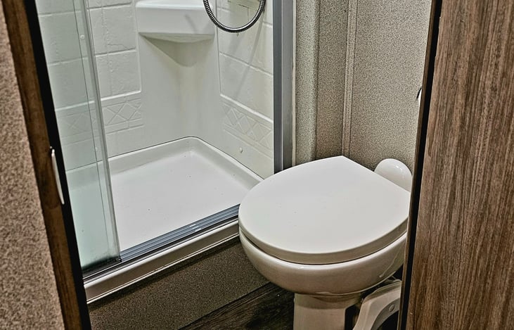 Bathroom with a shower that can easily accommodate my 6'3" 260 lb self.