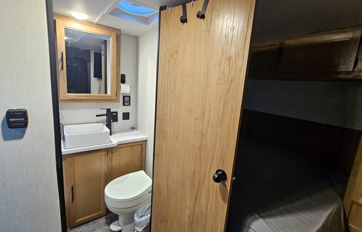 Luxury Bathroom features. Set water temp digitally. Medicine cabinet and large fan. Hooks on door and wall to hang towels and robes.