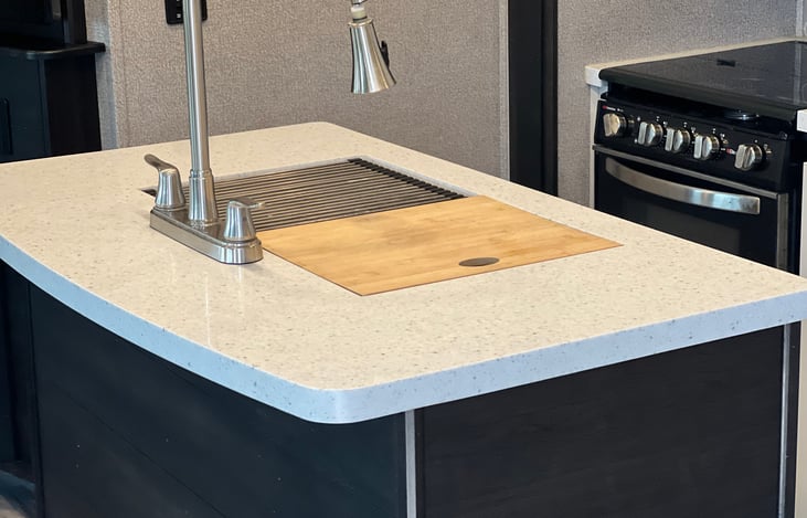 Island with sink and prep room.