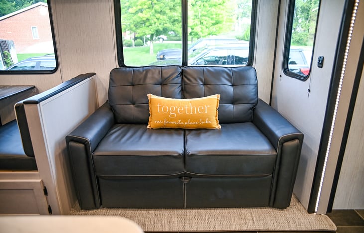 Relax and unwind on the plush hide-a-bed couch, offering extra sleeping space without sacrificing comfort—perfect for a restful night after your adventures.
