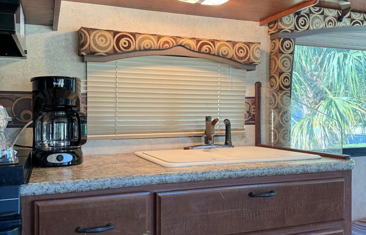 Kitchen with includes a microwave, gas stove and refrigerator/freezer. Coffee pot provided upon request.