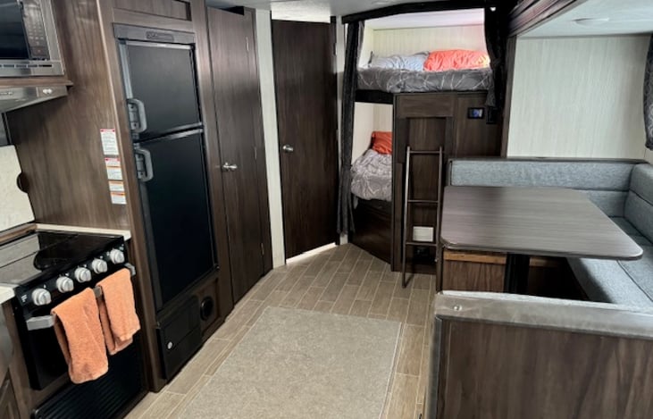 Looking from the front of the camper to rear, you can see the bunk beds and bathroom.