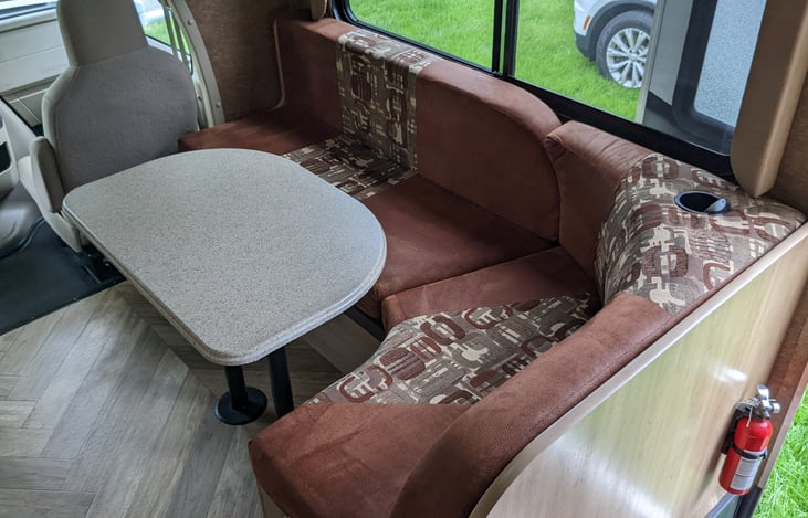 Dinette with seating for 4. Converts to bed (1 adult, 2 kids, comfortably). Extra seat pulls out at front. 3 seatbelts (one child seat anchor). Storage underneath.