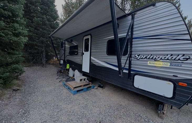 Full electric awning, outdoor speakers, LED lights. In this photo steps that fold out are not visible & awning is out about 1/3 . Awning must be closed during inclement weather and when unattended.