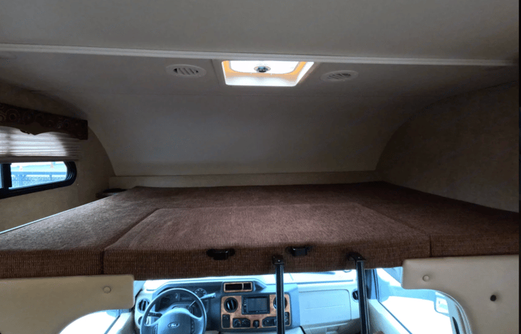 Queen size bed over cab.