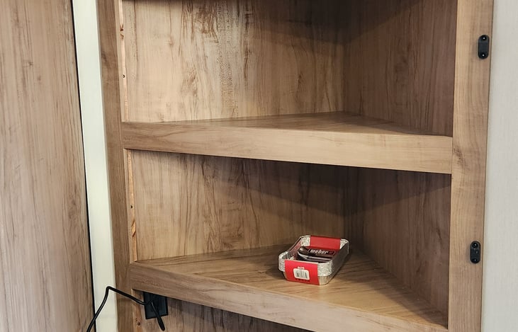 Hidden storage behind the T.V. and fireplace.