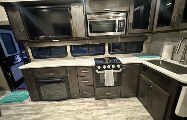 3 burner stove, oven, and convection microwave, with large sink.