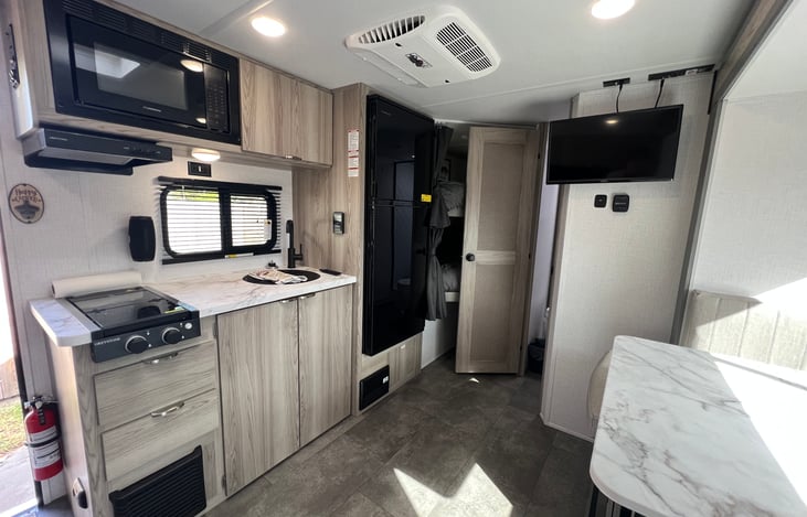 View of kitchen, bunk, and bathroom area