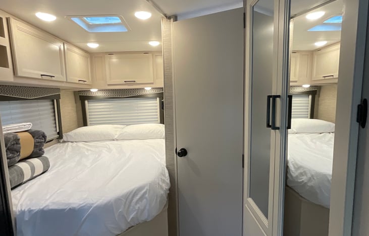 Bedroom, with privacy curtain. LED lighting throughout, USB charging station and mirrored closet. Added memory foam topper for extra comfort. Bedding included.