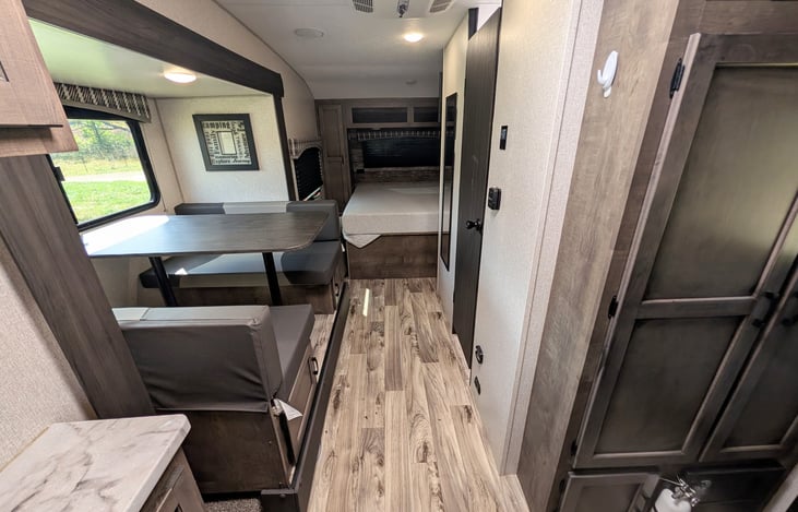 Smart layout featuring a chef’s rear galley and a slide-out dinette with a huge panoramic window. Enjoy great meals, natural light, and scenic views in a surprisingly spacious interior!
