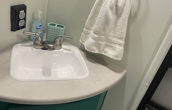 Bathroom with door for easy access from outside and half size shower.