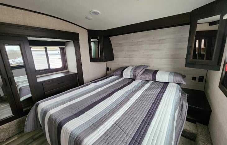 Queen size master with closets and drawers and storage under bed