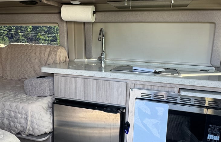 refrigerator, sink, convection oven/microwave, and propane stovetop.