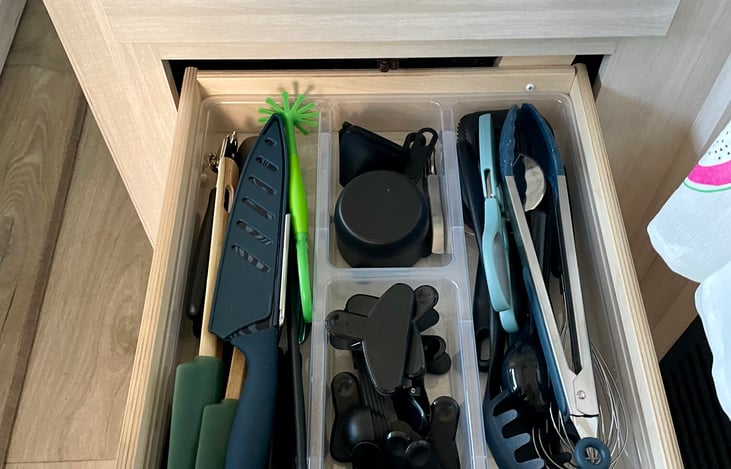 Some of the kitchen tools available. Including knifes, measuring cups & spoons, scissors, wine opener, clips, whisk, ice cream scoop and masher.