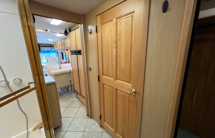 Pocket door between kitchen and bath and another pocket door between bath and private bedroom.