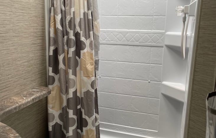 Walk in shower, sink and toilet