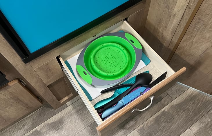 Kitchen knives, utensils, cutting board and colander included.