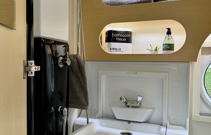 Folding sink maximizes shower space.