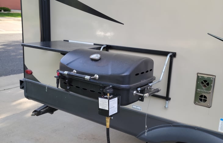 Out door propane grill and side table.