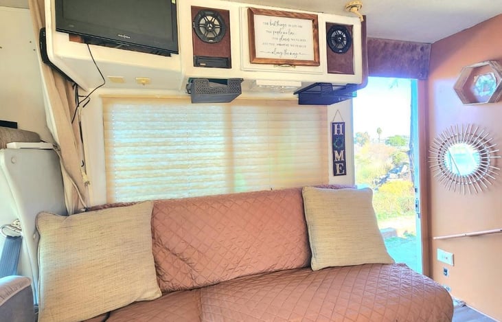 This couch slides down into a full-size bed and table across from it converts into a twin bed. We do provide sheets and blankets as well. Keep in mind there is cental air and heat if you need it.