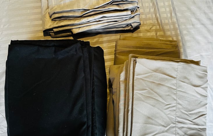 Three sets of sheets - one for the Murphy bed, one for the pop top, and one extra set. Stored in the bottom cubby under the Murphy bed