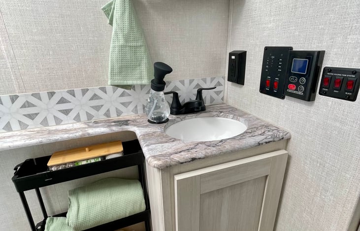 Black tank read out (sewage), gray tank read out (bathroom & kitchen sink used water), fresh water tank (is only used when not connected to city water and is the water you have left in the tank).