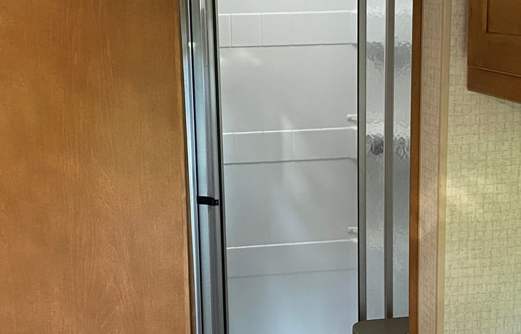 Corner shower in bathroom with skylight