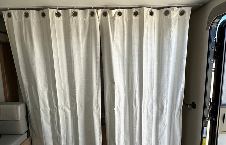 Curtain by queen bed