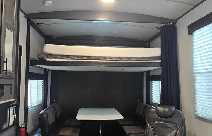 Queen Bunk Beds. Top has a Matress on it, Bottom is just the Couches that fold out into a Queen bed, or it can just be a sitting area with the table.