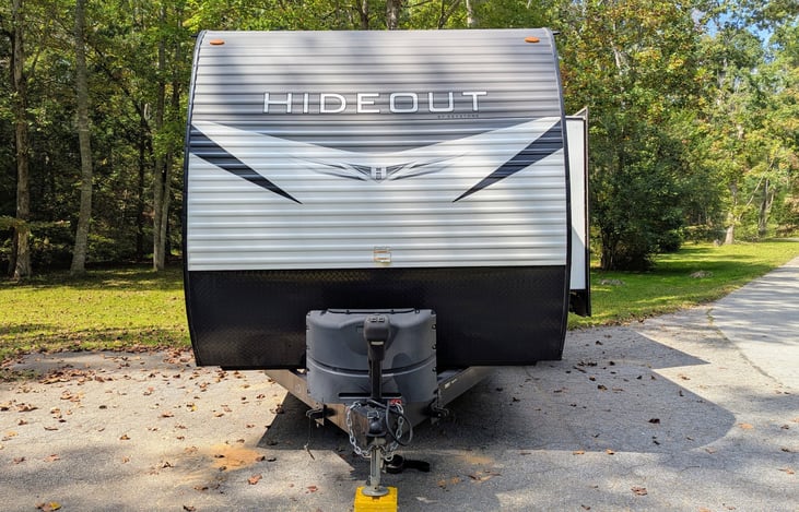 This spacious 2021 Keystone Hideout 250BH sleeps 8 with a bunkhouse layout, outdoor kitchen, and upscale interior. Features include: electric fireplace, central vacuum, outdoor kitchen, and more.