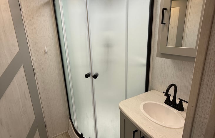 Corner shower and newly installed swivel faucet