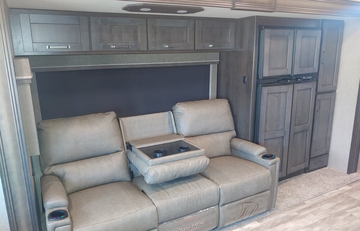 Comfortable recliner with meassage  and over sized fridge.