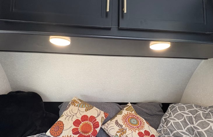 Overhead lights above queen, bed