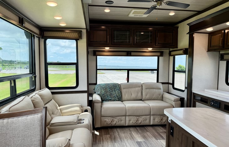 Star Comfort: Power-reclining luxury theater seating and a large tri-fold sofa facing panoramic scenic windows.