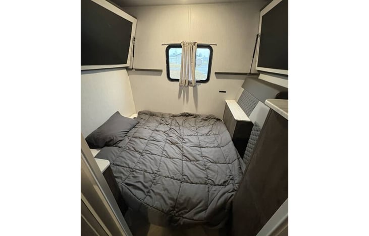 Bunk room with bunks folded up and foldout pulled out