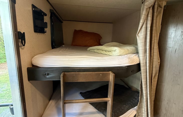 Cozy bunk quarters each with a curtain for added privacy.