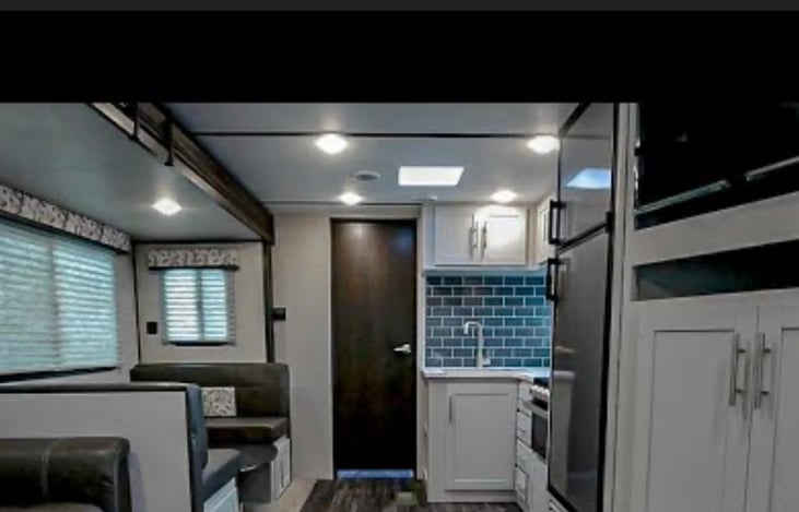 View of kitchen from recliners in rear.
