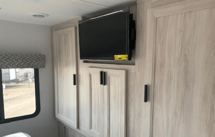 Private bedroom with two closets and shelves in middle.