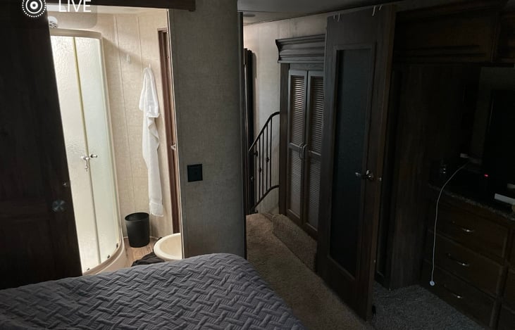 Master bedroom looking into the bathroom and down the hall to the kitchen.