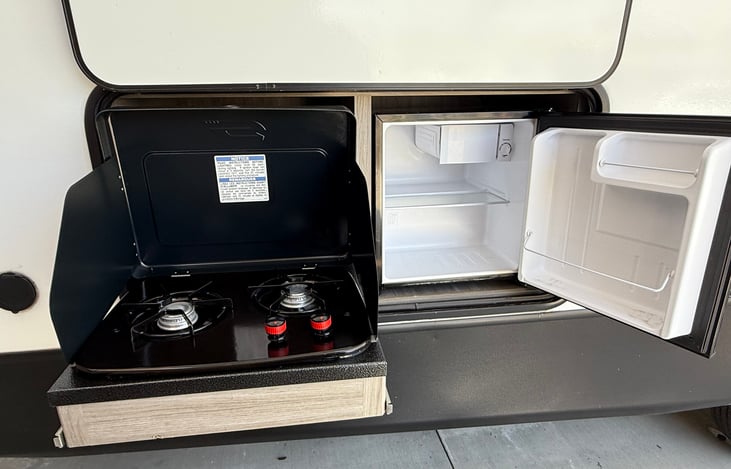 Easy access mini-fridge and two burner range.